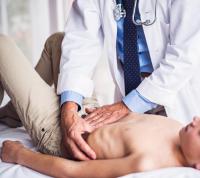 doctor examining child for gastrointestinal disorder